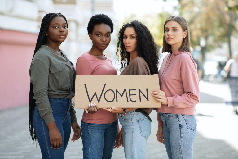 International group of four young women demonstrating outdoors